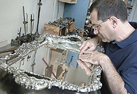 Jeffery Herman inspecting antique silver tray